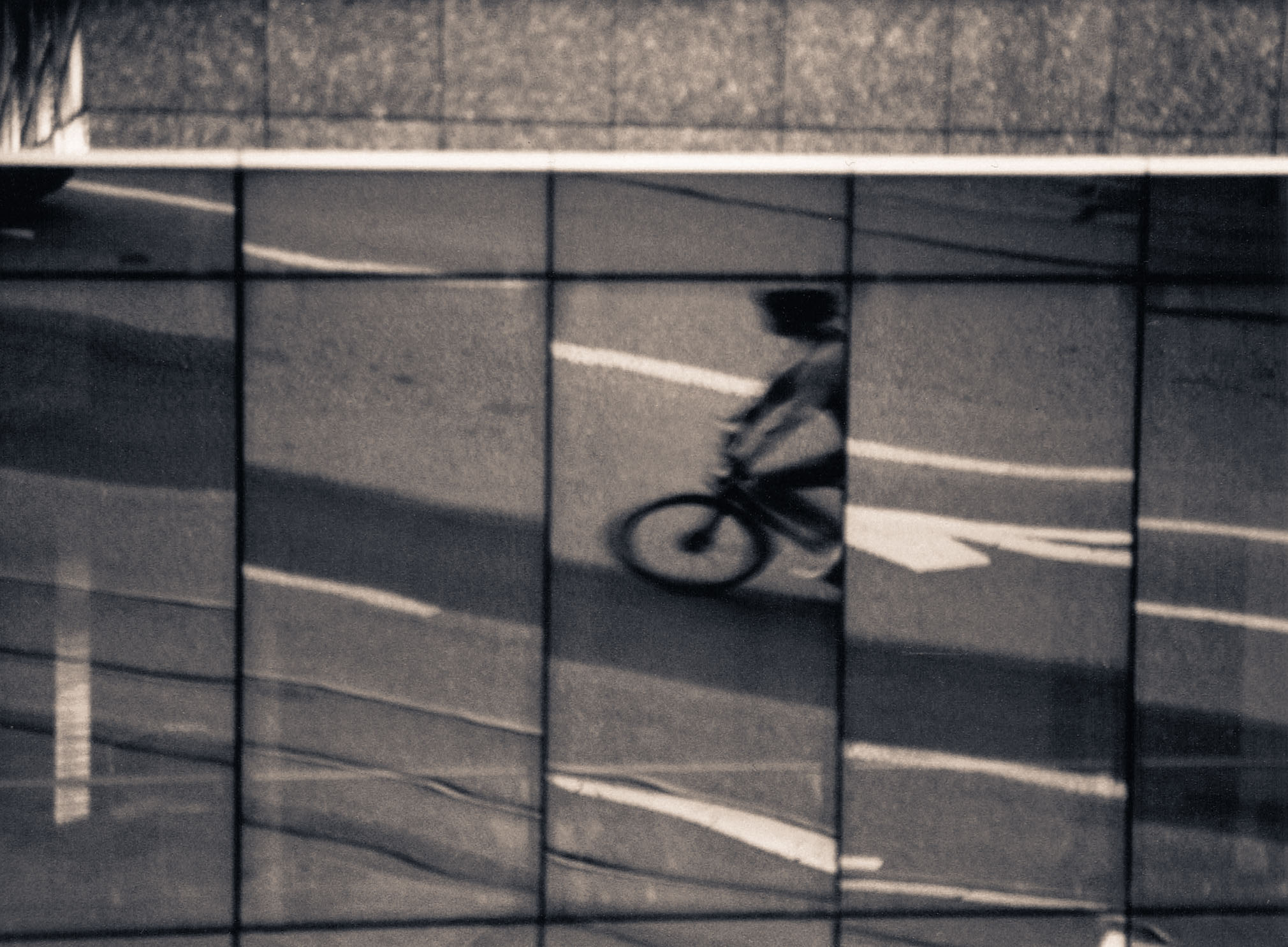Reflections of a commuter, captured with the Minolta XD7