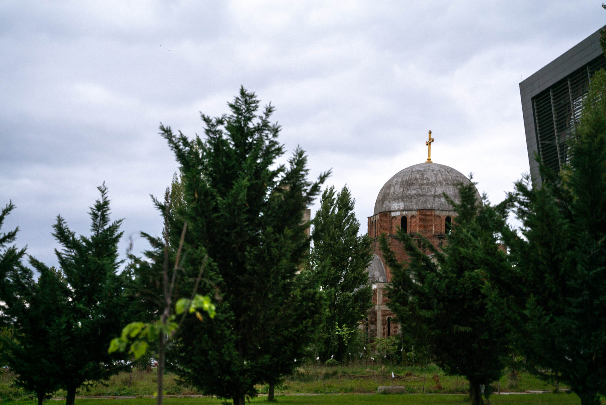 an orthodox church right next to the national university library of Kosovo