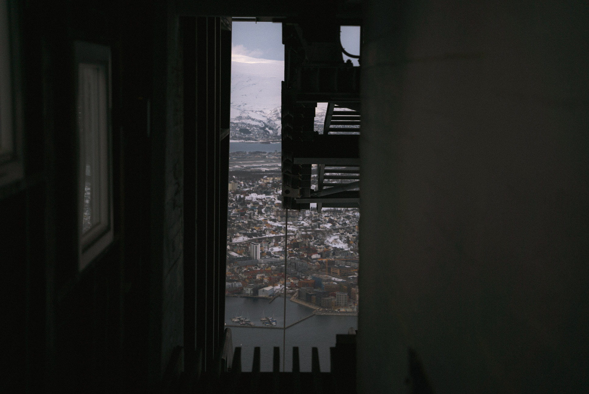 inside the cable car station, looking down at Tromsø